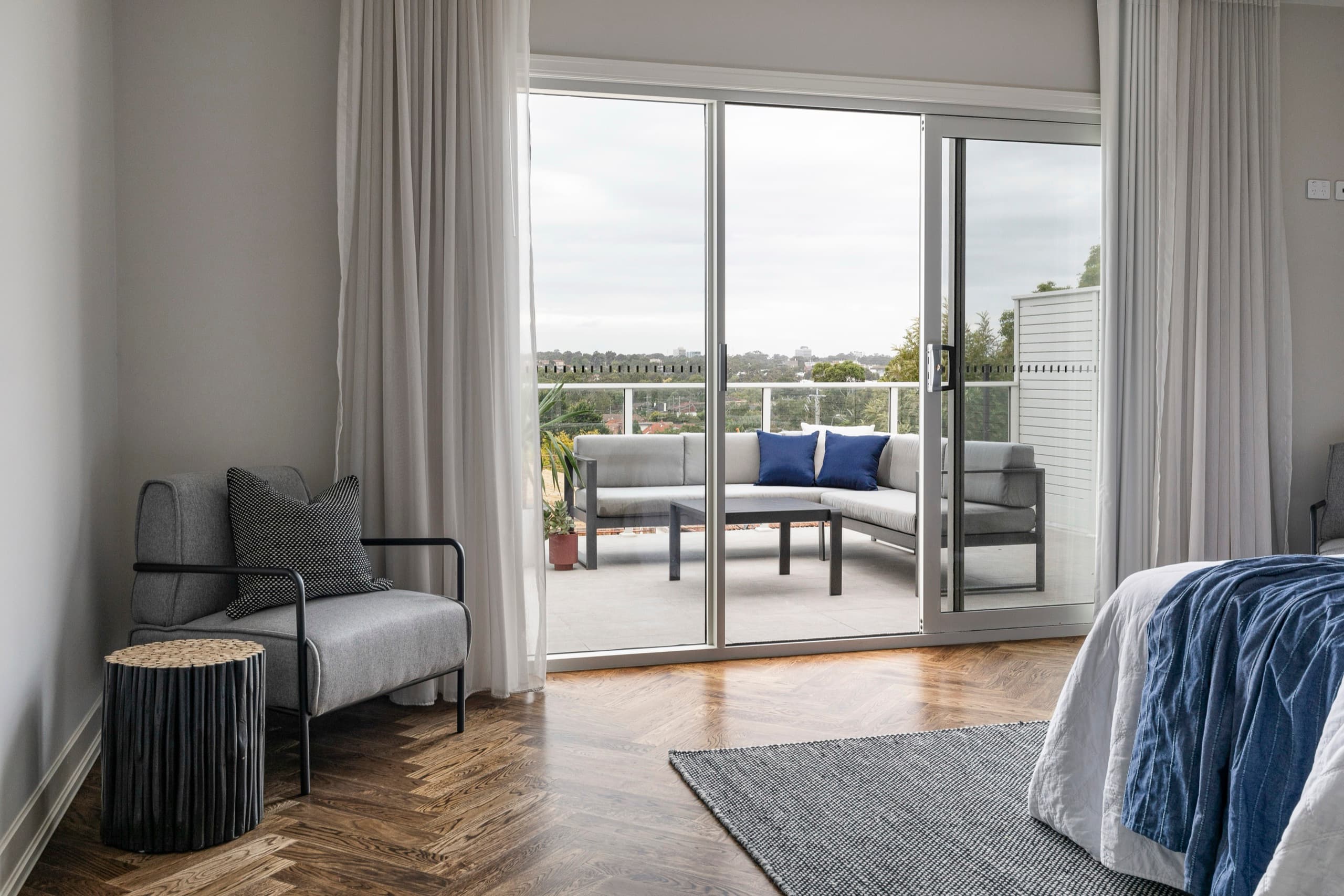 Sheer curtains drawn back from a bedroom balcony door, Melbourne install