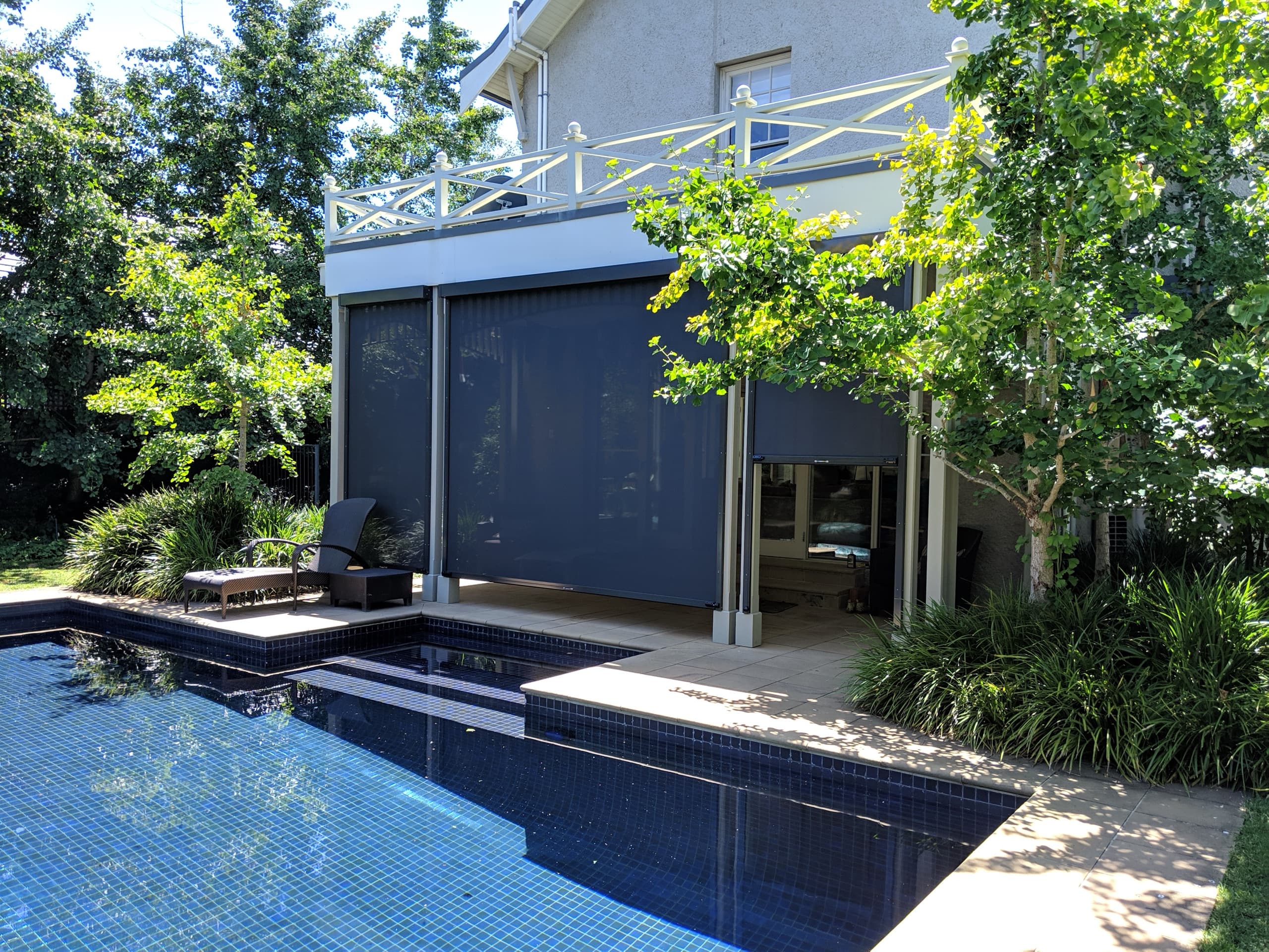 Charcoal zip screen blinds enclosing a pool house alfresco
